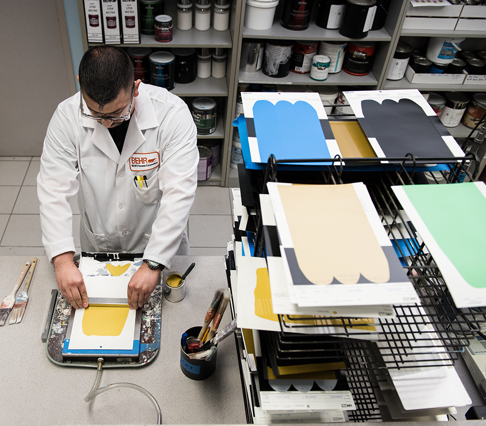 A person in a Behr Lab coat working on a color drawdowns