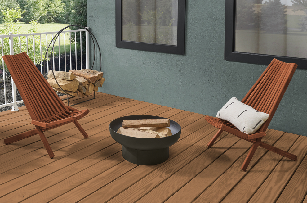 Deck with two chairs around a fire pit.