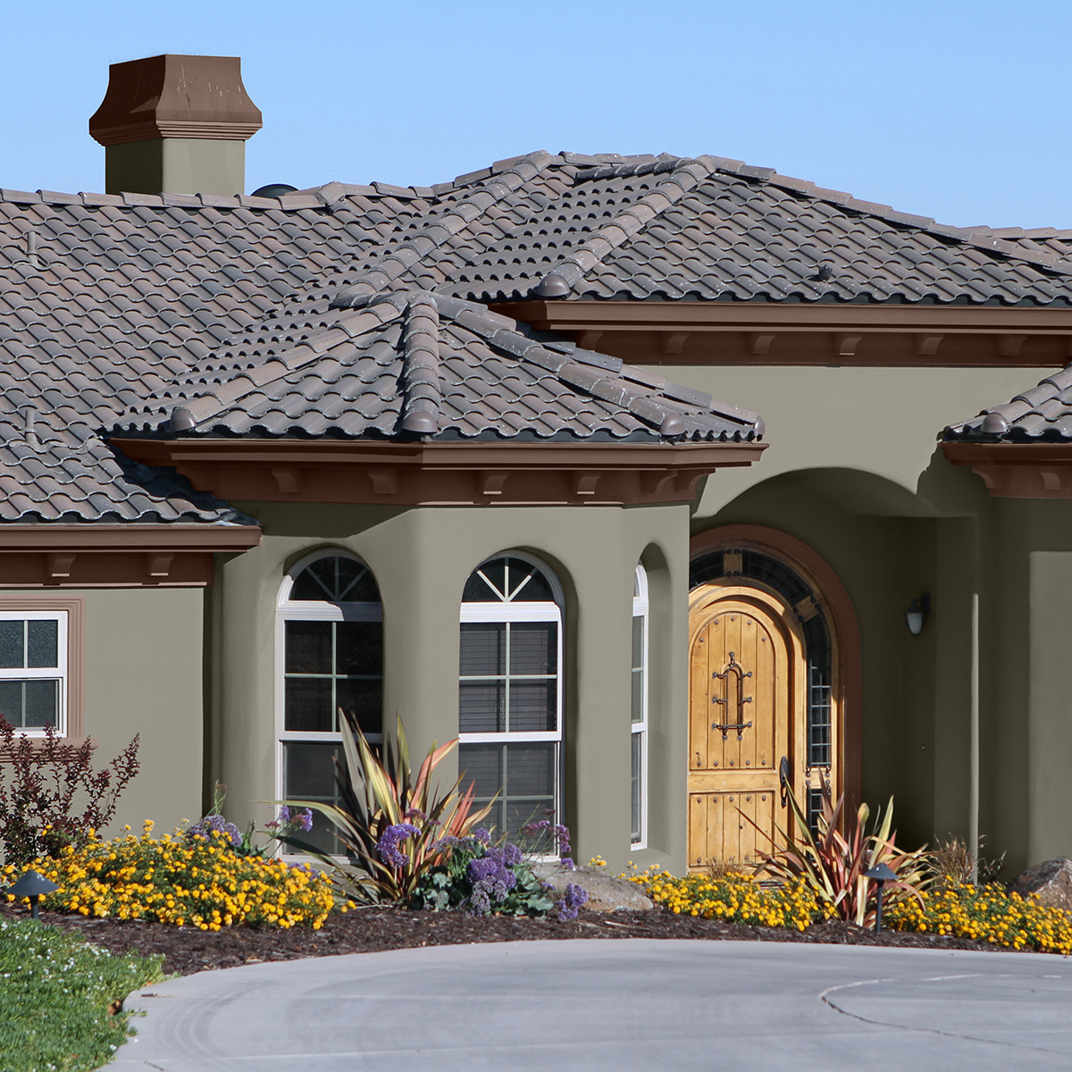 A green house exterior painted with Behr Dynasty Exterior paint