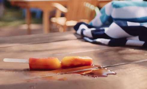 Popsicle melting on a stained deck