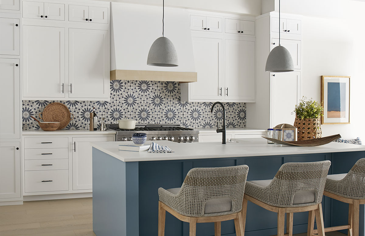 Kitchen showcasing navy blue kitchen island vs. white cabinets, featuring an Adirondack Blue island base, White 52 cabinetry, patterned tile backsplash, and modern bar seating.